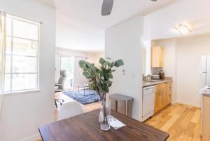a kitchen with a table with a vase of flowers on it at Fremont 1br w parking balcony nr groceries SFO-1508 in Fremont