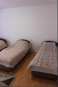 two beds sitting next to each other in a bedroom at Apartment Ilidza-SK 2 in Sarajevo