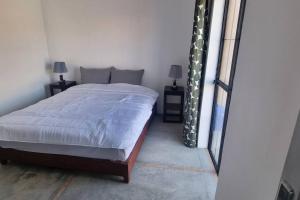 a bedroom with a bed and two lamps and a window at city garden Kech in Marrakech +97 photos