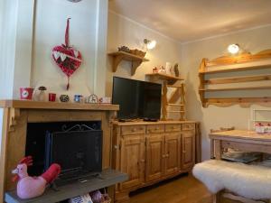 a living room with a tv and a fireplace at Edelweiss Apt29 in Pretoro
