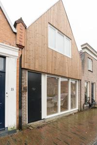 a building with large windows on the side of it at Studio Loet in Schagen