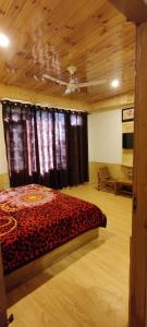 a bedroom with a bed with a cheetah comforter at Hotel Sun Mark in Manāli