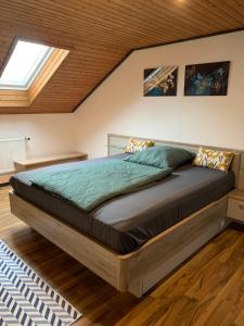a bedroom with a large bed in a attic at Maya in Oberwindach