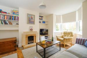 a living room with a couch and a fireplace at 41 Eastward Ho in Leiston