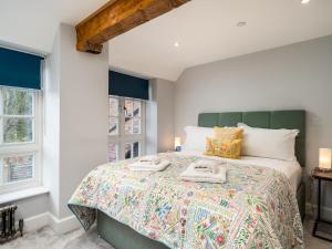 a bedroom with a bed with two towels on it at Pass the Keys Converted Hop House Apt - Old Amersham - Chilterns in Amersham