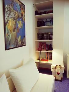 a room with a white bed and a painting on the wall at Sacred Way Modern apartment in Athens