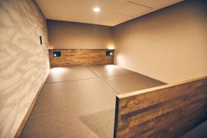 a large empty room with a bed in it at ルクス箱根湯本 LUX HAKONE YUMOTO in Hakone +50 photos