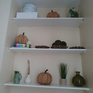 a shelf with pumpkins and bowls on it at sweet dreams A in London