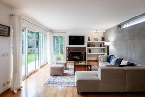 a living room with a couch and a fireplace at FLH Restelo Duplex with Garden & Parking in Lisbon