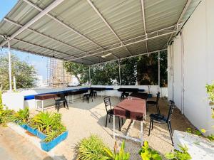 a patio with a table and chairs under awning at TRIP IN HoSTEL in Udaipur