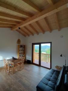a living room with a couch and a table and a balcony at PicuAstur in Cangas de Onís