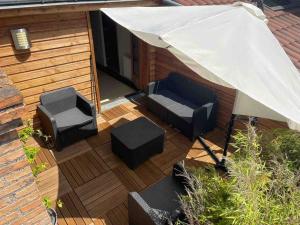 an overhead view of a patio with two chairs and an umbrella at Spacieux 5 pers Centre+Terrasse in Clermont-Ferrand