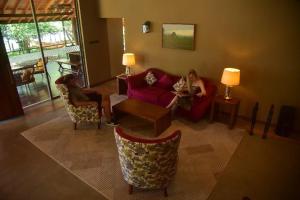 two women are sitting in a living room at Allure Yala Luxury Suites by Allure Leisure in Yala +94 photos