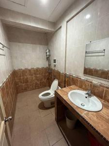 a bathroom with a sink and a toilet in it at [El Casa] Homestay Miri (8 Pax) in Miri