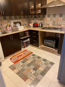 a kitchen with a mosaic floor in a kitchen at شقة in Cairo