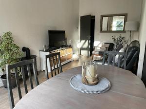 a dining room with a table and a living room at Pass the Keys The Cabin Stylish and Elegant for 4 and Furry Friends in Hayfield