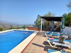 a villa with a swimming pool with a view at Vine Ridge Studio and Apartment in Comares