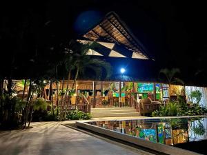 a resort with a swimming pool and a restaurant at night at Lio Villas Resort in El Nido