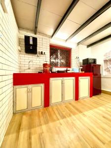 a kitchen with a red counter in a room at Bandra Cottage (With Yard) in Mumbai