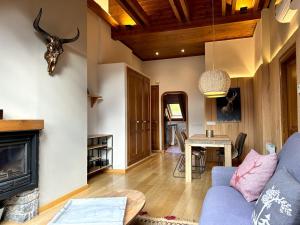 a living room with a blue couch and a fireplace at Àtic de luxe i rústic a Esterri d'Àneu by RURAL D'ÀNEU in Esterri d'Àneu