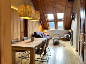 a living room with a table and a couch at Àtic de luxe i rústic a Esterri d'Àneu by RURAL D'ÀNEU in Esterri d'Àneu