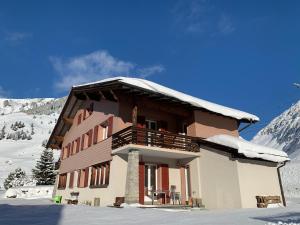 un gran edificio con nieve en el techo en Swiss Alpine Hideaway, en Sedrun