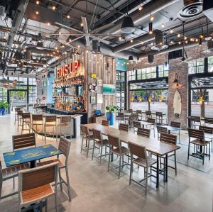 a restaurant with tables and chairs and a bar at Margaritaville Hotel San Diego Gaslamp Quarter in San Diego