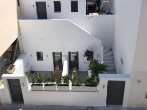 an aerial view of a white building with plants at Nostos Apartments Fira in Fira