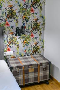 a room with a wall with a tropical wallpaper at Acropolis Urban Oasis in Athens