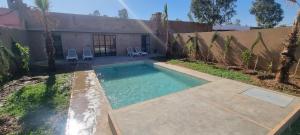 a swimming pool in the backyard of a house at city garden Kech in Marrakesh
