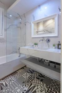 a white bathroom with a sink and a shower at Acropolis Urban Oasis in Athens