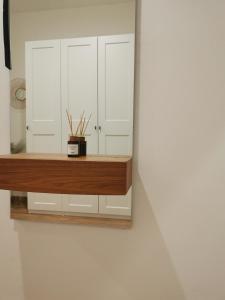 a room with white cabinets and a wooden counter at Atlas Apartment in the historical center of Košice with free private parking in Košice
