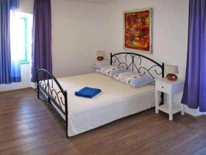 a bedroom with a bed with a nightstand and a bed sidx sidx sidx sidx at Villa Angiolina in Višnjan
