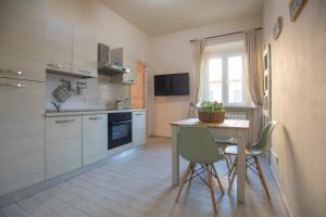 a kitchen with a table and two chairs and a counter at L'acciughina in Portoferraio