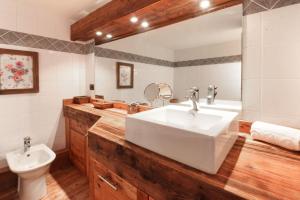 a bathroom with a large white sink and a toilet at Clos des Vorgeats - Duplex Beside Golf Course - Patio - UTMB in Chamonix-Mont-Blanc +22 photos