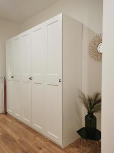 a white closet with white cabinets in a room at Atlas Apartment in the historical center of Košice with free private parking in Košice