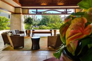 a living room with a couch and chairs and a table at Ko Olina Beach Villas O1404 in Kapolei