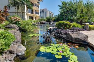 a pond with a bunch of lilies in a garden at Ko Olina Beach Villas O1404 in Kapolei