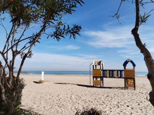 a playground on a beach next to the ocean at COSTA AZUL in Puerto de Sagunto