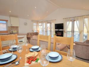 a dining room with a table with wine glasses at 3 Bed in Okehampton 49134 in Okehampton