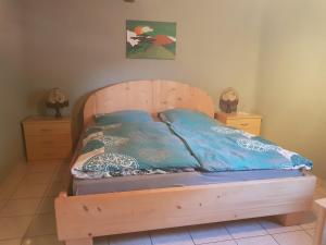a bedroom with a wooden bed with two night stands at Scholz 