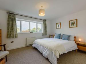 a bedroom with a large bed and a window at 3 Bed in Camber 87987 in Camber