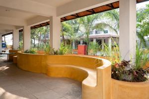 a wooden bench in a lobby with plants at Sterling Stolen Heaven Lonavala in Lonavala +40 photos