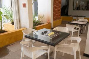 a chess board on top of a table with chairs at Sterling Stolen Heaven Lonavala in Lonavala