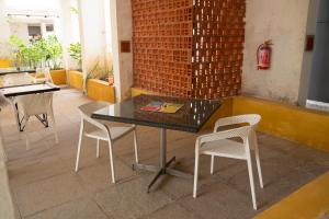 a black table and chairs in a room at Sterling Stolen Heaven Lonavala in Lonavala