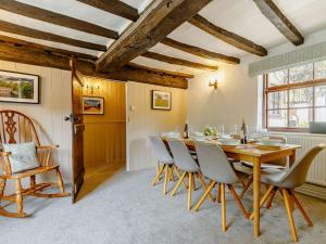 a dining room with a wooden table and chairs at 4 Bed in Markeaton 88665 in Derby