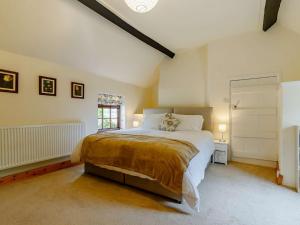 a bedroom with a large bed and a window at 4 Bed in Markeaton 88665 in Derby