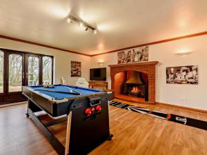 a living room with a pool table and a fireplace at 5 bed in Burridge 89078 in Curdridge