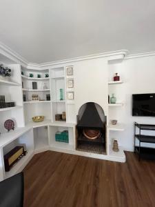 a living room with a fireplace in the wall at LA CASA DEL JAIME in Mora de Rubielos