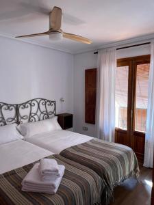 a bedroom with a bed with a ceiling fan at LA CASA DEL JAIME in Mora de Rubielos